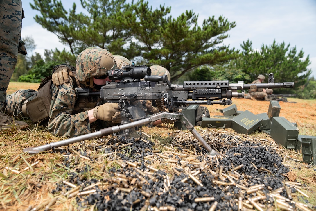 U.S. Marines fire M240B medium machine guns at Camp Hansen, Okinawa, Japan, June 24.