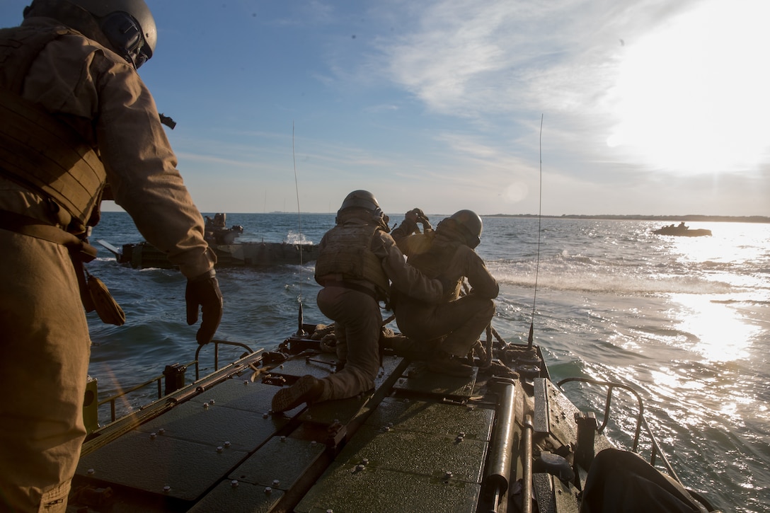 U.S. Marines prepare rope for a troop-to-troop transfer off of Onslow Beach during a three-day ship-to-shore exercise on Camp Lejeune, N.C., June 26.