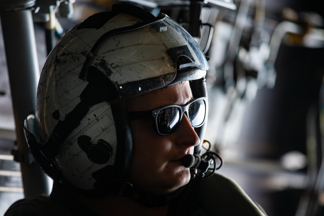 A U.S. Marine communicates with in-flight crew during the squadron’s deployment for training at Alpena Combat Readiness Training Center, Michigan, June 19.