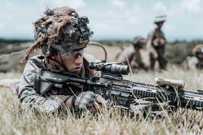 A U.S. Marine observes targets downrange during live-fire maneuver drills on Camp Schwab, Okinawa, Japan, June 18.
