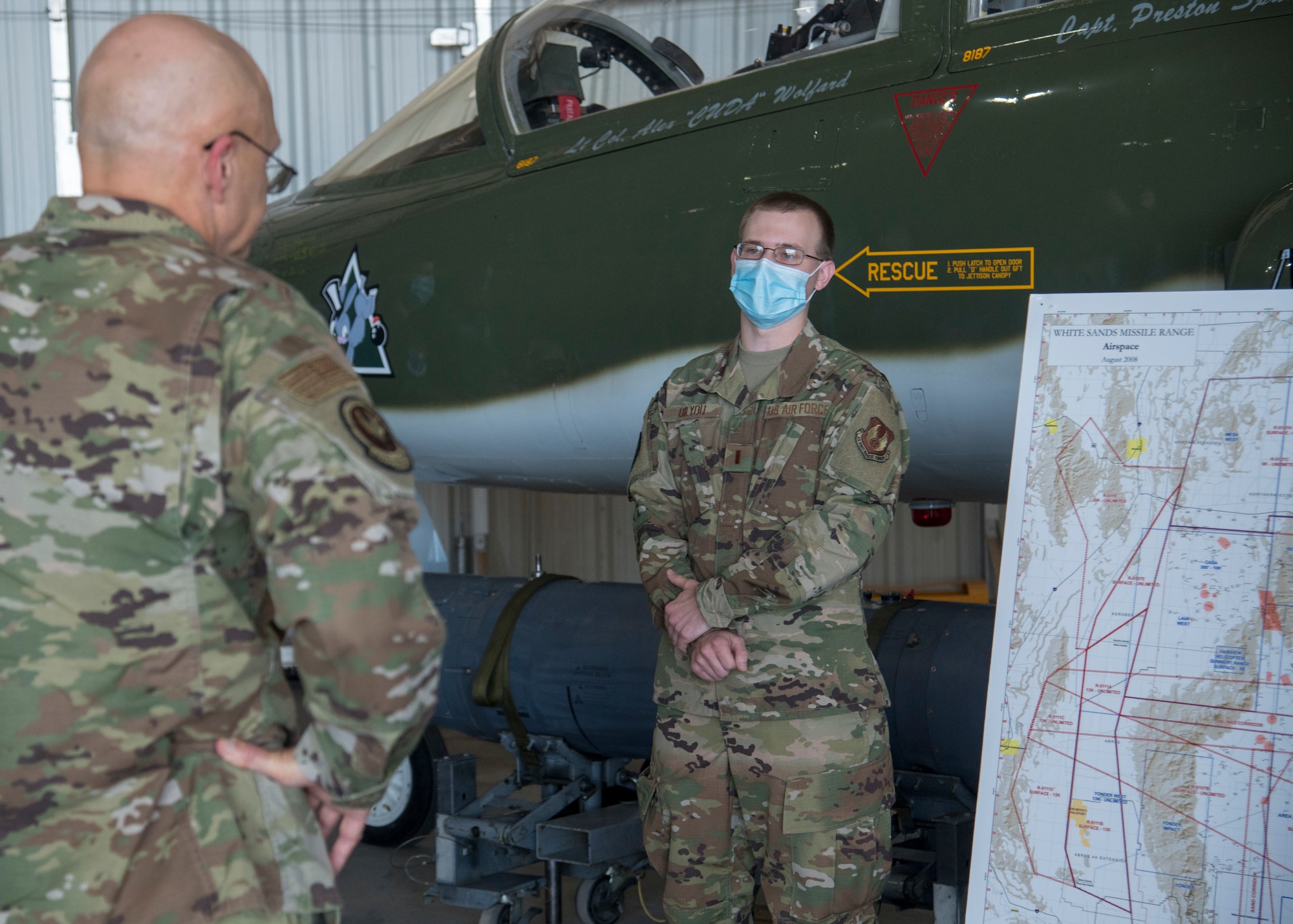 Gen. Arnold W. Bunch Jr., left, Air Force Materiel Command commander, receives a briefing from 2nd Lt. Chase Bilyou, White Sands Missile Range 586th Flight Test Squadron Detachment 1 weapon systems test manager, June 29, 2020, at the 704th Test Group on Holloman Air Force Base, N.M. Detachment 1 sponsors Air Force test customers onto the missile range and facilitates any WSMR testing support required. (U.S. Air Force photo by Senior Airman Collette Brooks)