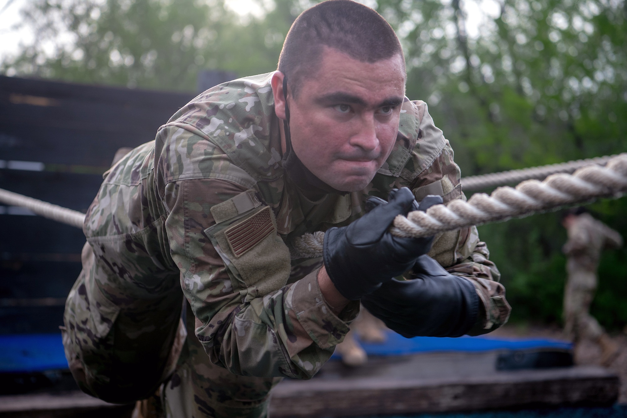 Jesus Hughes, U.S. Air Force basic training trainee, runs through an obstacle course May 21 at Joint Base San Antonio-Chapman Annex.