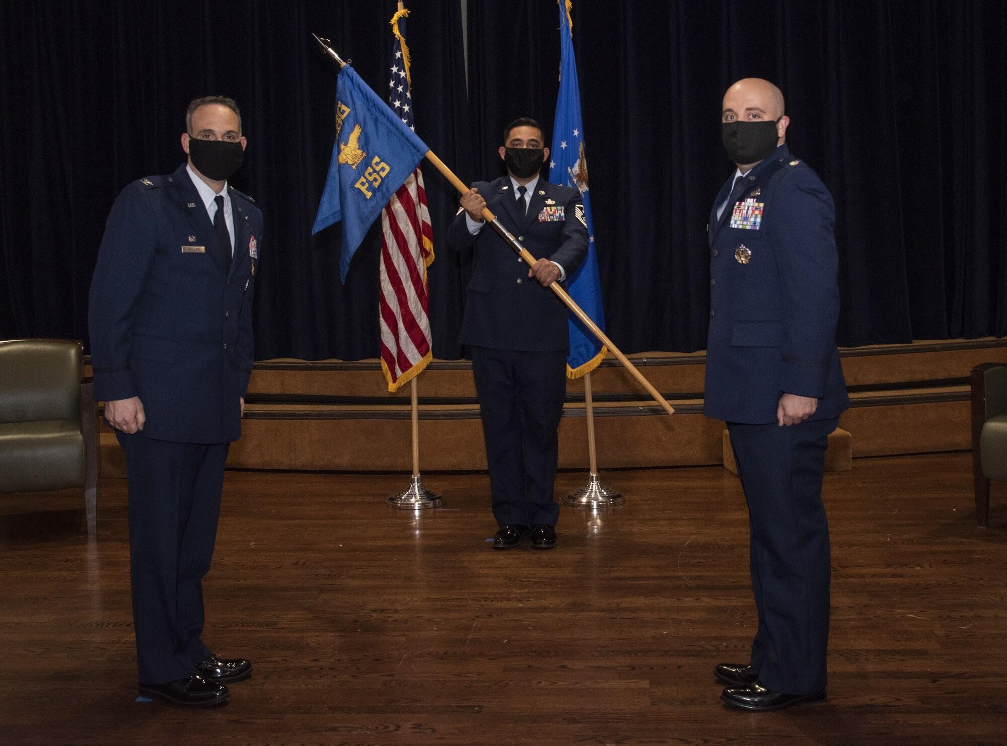 U.S. Air Force Col. Edward Phillips, 6th Mission Support Group commander, ceremoniously passes the 6th Force Support Squadron (FSS) guidon to Lt. Col. James Lupher, the in-coming 6th FSS commander during a change of command ceremony at MacDill Air Force Base, Fla., June 23, 2020.