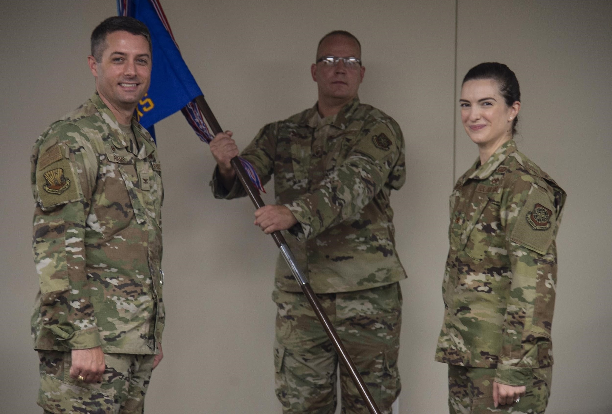 U.S. Air Force Col. Wes Adams, 6th Maintenance Group commander, ceremoniously passes the 6th Aircraft Maintenance Squadron (AMXS) guidon to Maj. Jennifer Lindberg, the in-coming 6th AMXS commander during a change of command ceremony at MacDill Air Force Base, Fla., June 25, 2020.