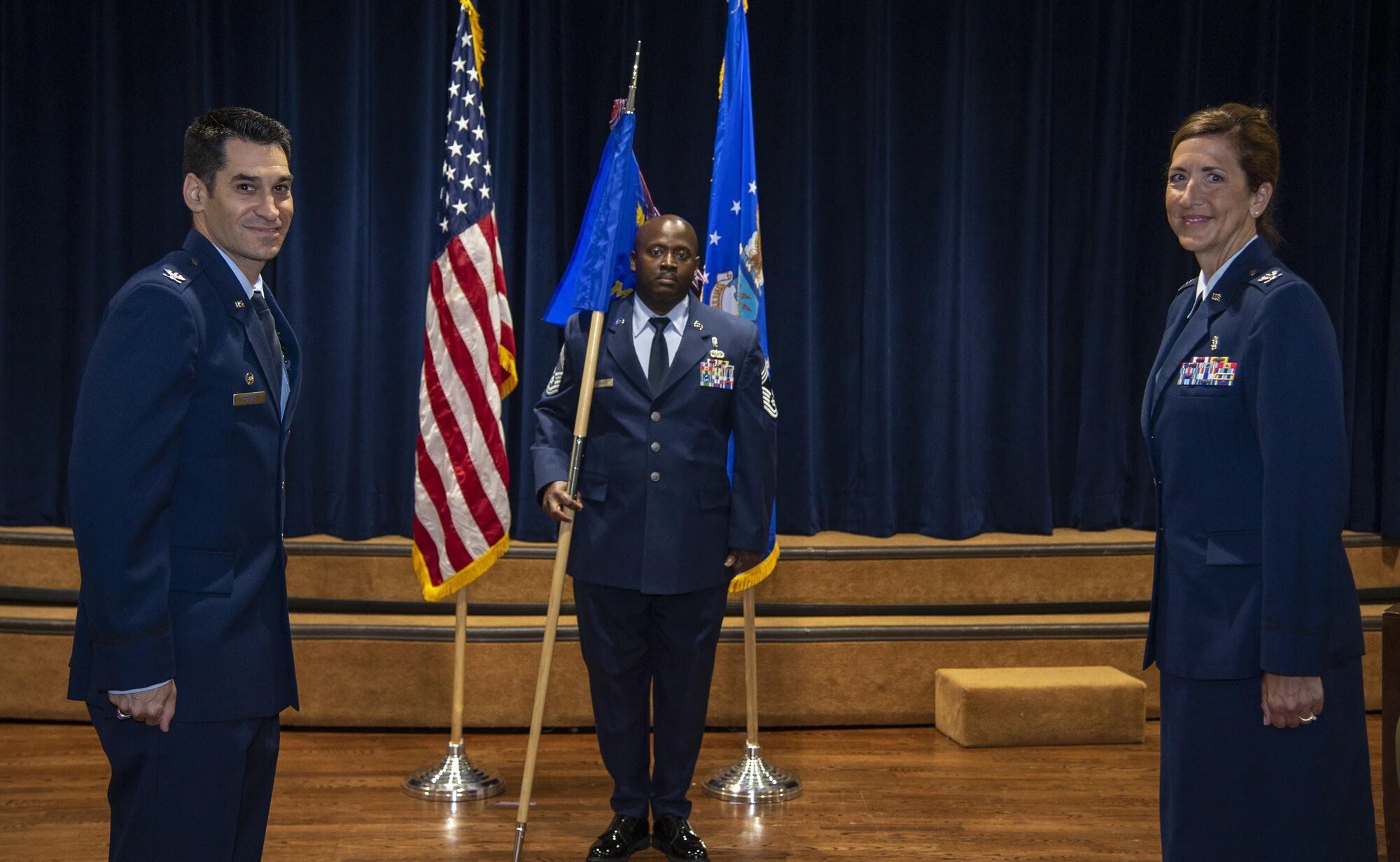 U.S. Air Force Col. Benjamin Robins, 6th Air Refueling Wing commander, ceremoniously passes the 6th Medical Group (MDG) guidon to Col. Courtney Finkbeiner, the in-coming 6th MDG commander during a change of command ceremony at MacDill Air Force Base, Fla., June 26, 2020.