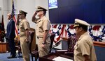 Division Technical Director Paul Mann (far left), outgoing Commanding Officer Capt. Ray Acevedo, incoming Commanding Officer Capt. Andrew Hoffman, and Chief Staff Officer Raoul Bustamante (far right) stand at attention during a change of command ceremony, held June 30 at Naval Surface Warfare Center, Port Hueneme Division.