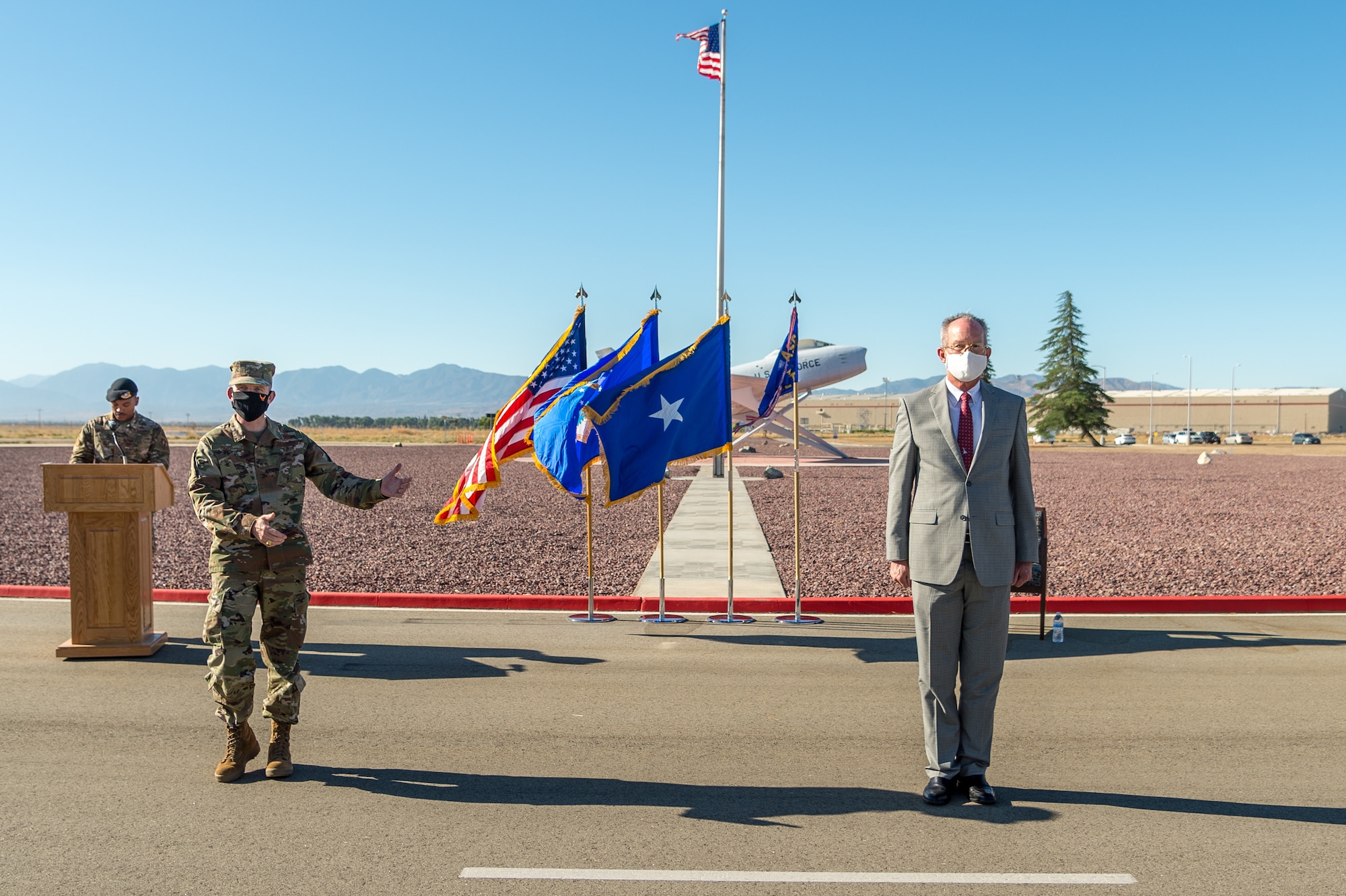 Brig. Gen. Matthew Higer, 412th Test Wing Commander, transfers leadership of Operating Location Air Force Plant 42 to Dr. David Smith during a Change of Leadership Ceremony at Plant 42 in Palmdale, California. (Air Force photo by Ethan Wagner)