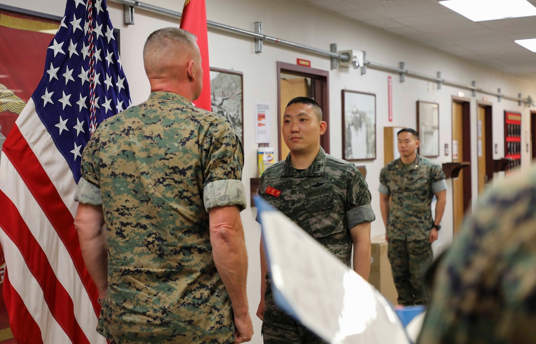 The Commander of U.S. Marine Corps Forces Korea, MajGen Bradley S. James, awards Capt JaeWon Choi, former liason officer (LNO) for the ROK Marine Corps to MARFORK, the Navy and Marine Corps Achievement Medal at the MARFORK Headquarters on 24 June 2020. Capt Choi was awarded for his outstanding service to the U.S. Marine Corps and MARFORK, making noticeably positive impacts to the command's mission from 2017 to 2019. The LNO position personifies the relationship existing between U.S. and ROK Marines that is founded on trust and mutual respect (U.S. Marine Corps Photo by Sgt. Parker R. Golz)