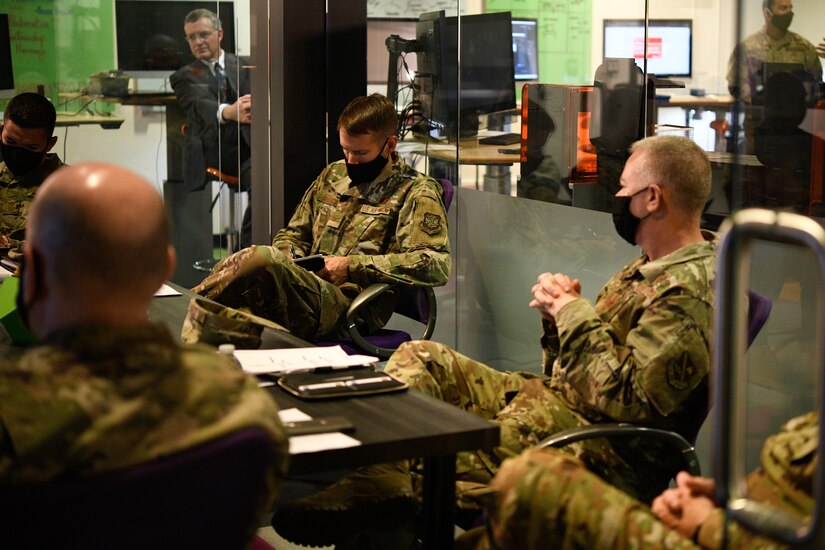 Col. Stephen P. Snelson, 89th Airlift Wing commander, and Col. Tyler R. Schaff, 316th Wing and Joint Base Andrews commander, attend a 316th Wing mission briefing during an immersion tour at the SparkX Cell Innovation and Idea Center, Joint Base Andrews, Md., on June 29, 2020.