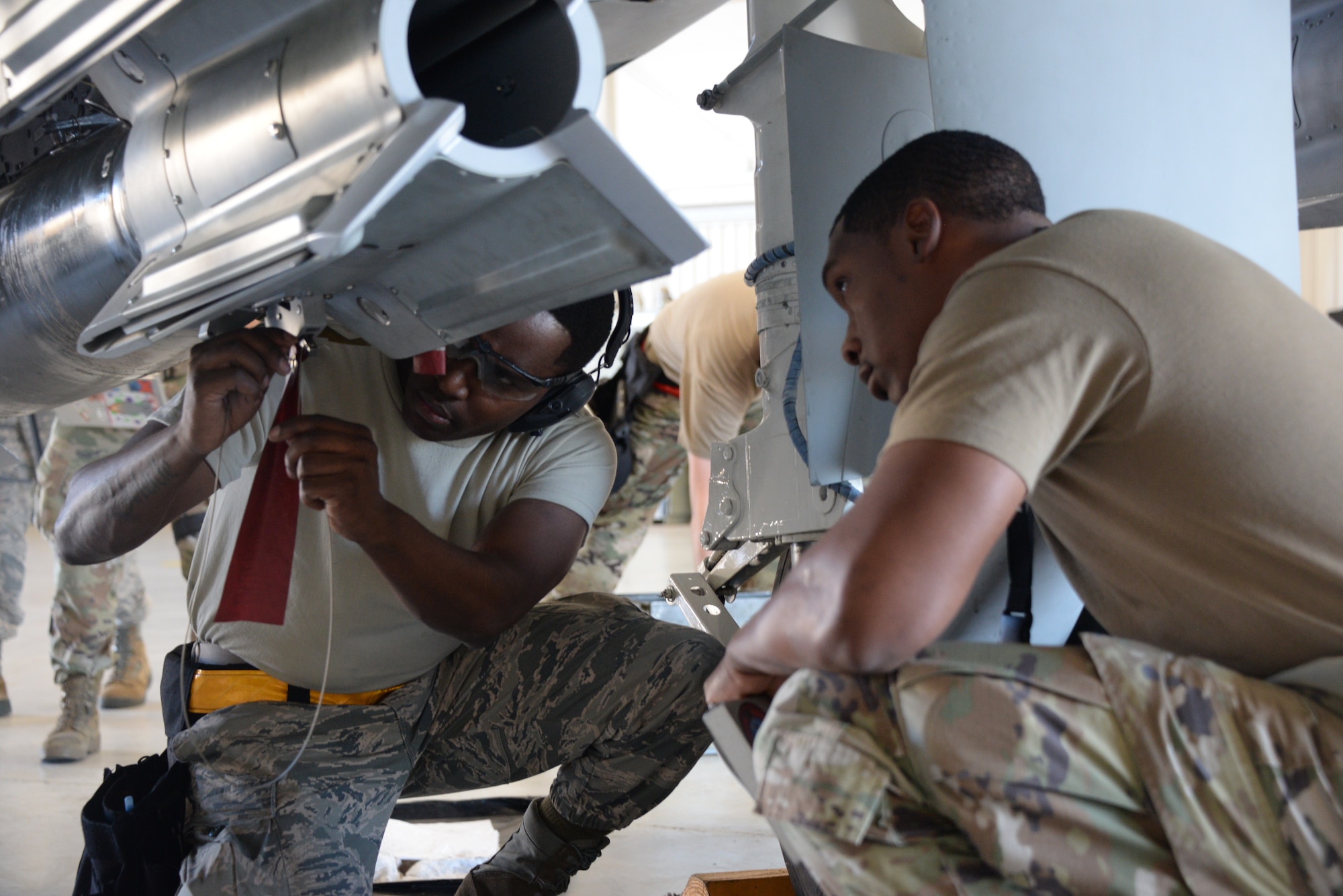 A photo of Airmen working on munitions