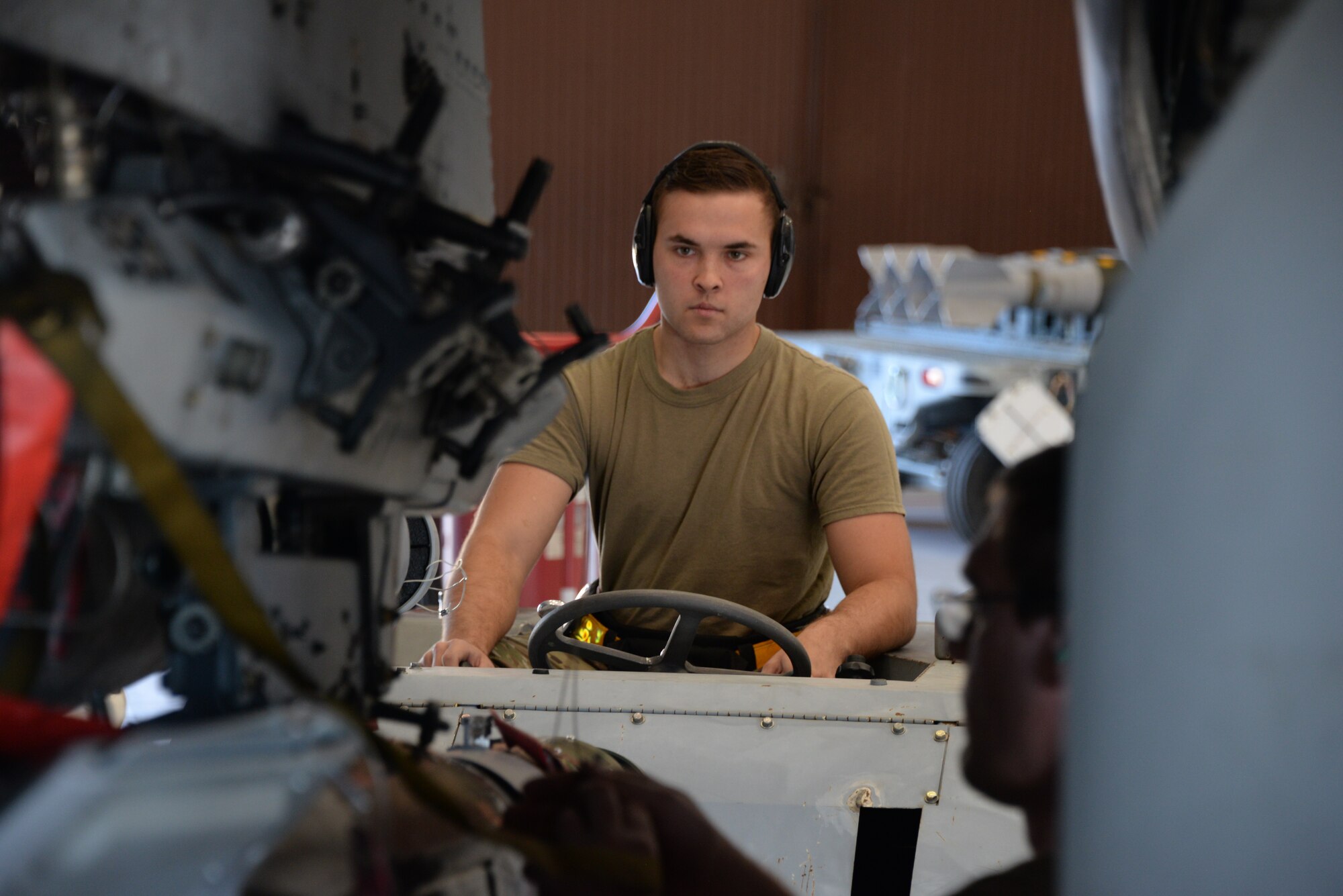 A photo of an Airman working on munitions