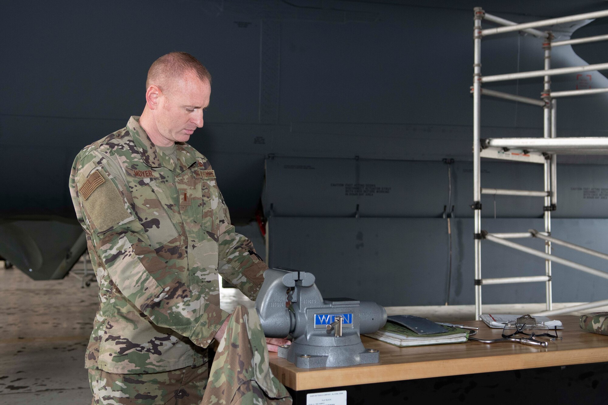 Photo of Airman reading paperwork at a table.