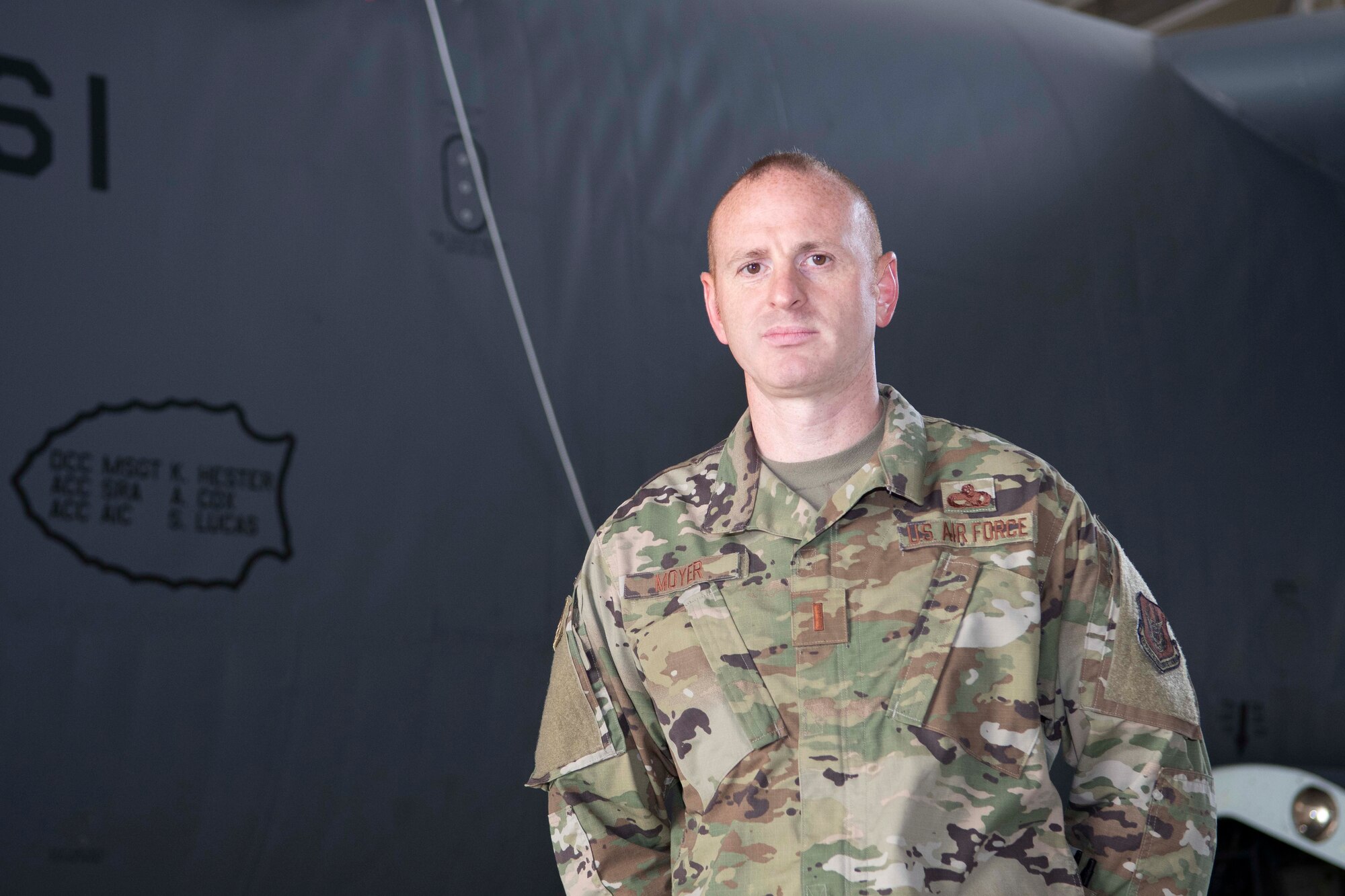 Photo of Airman standing in front of a B-52 Stratofortress.