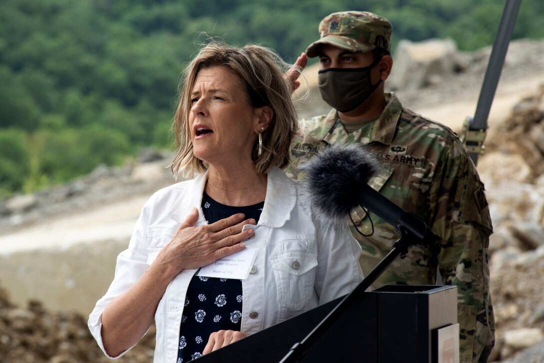 Tennessee District 40 Rep. Terri Lynn Weaver sings the National Anthem at the Center Hill Lake Auxiliary Dam July 1, 2020 during a ceremony celebrating the completion of the last phase of repairs for the $353 million Center Hill Dam Safety Rehabilitation Project. The U.S. Army Corps of Engineers Nashville District recently finished constructing a roller compacted concrete berm to reinforce the auxiliary dam at Center Hill Lake, a secondary earthen embankment that fills a low area in the landscape just east of the main dam. (USACE Photo by Lee Roberts)