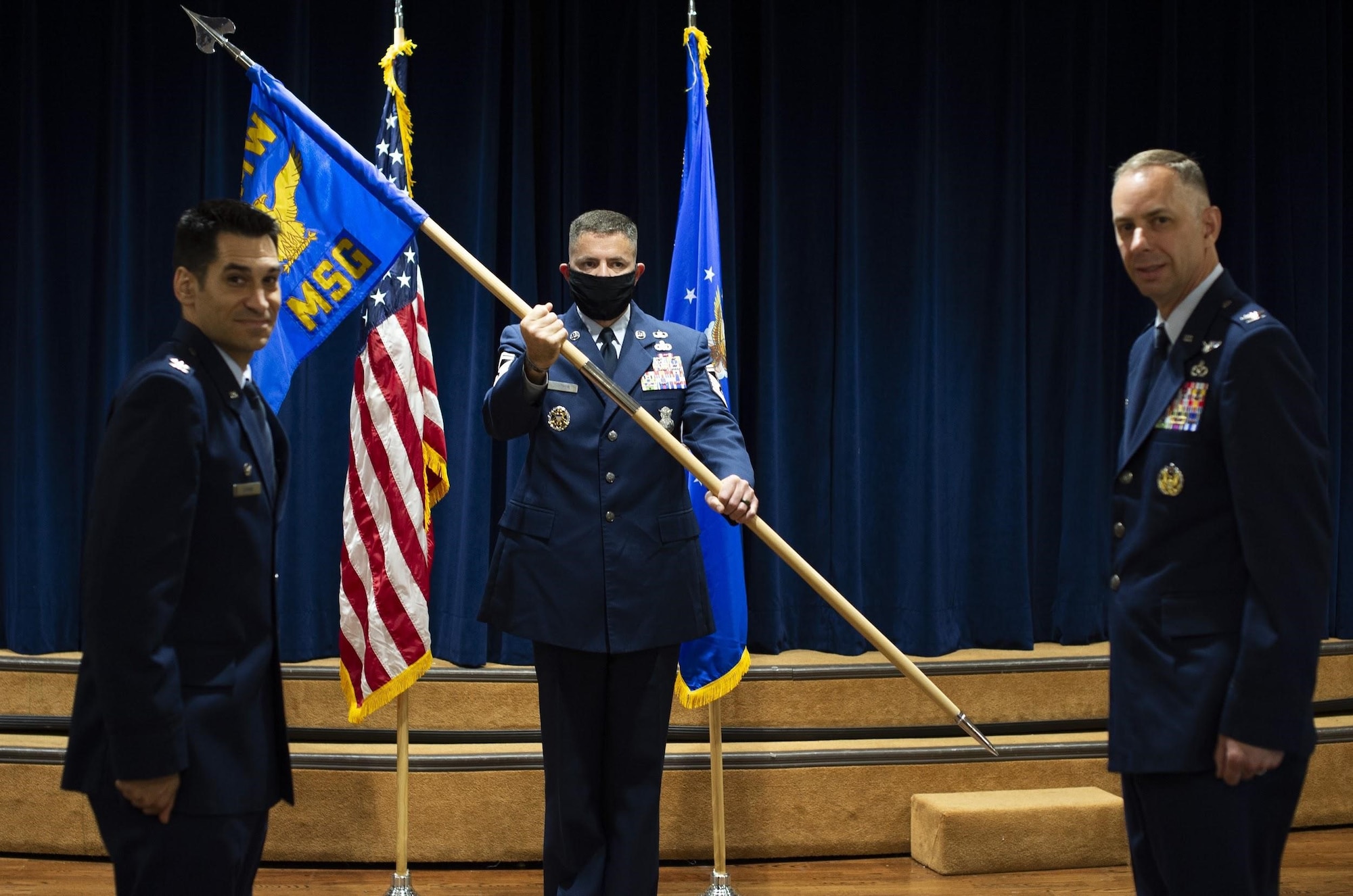 U.S. Air Force Col. Benjamin Robins, 6th Air Refueling Wing commander, ceremoniously passes the 6th Mission Support Group (MSG) guidon to Col. Jason Loschinskey, the in-coming 6th MSG commander during a change of command ceremony at MacDill Air Force Base, Fla., June 24, 2020.