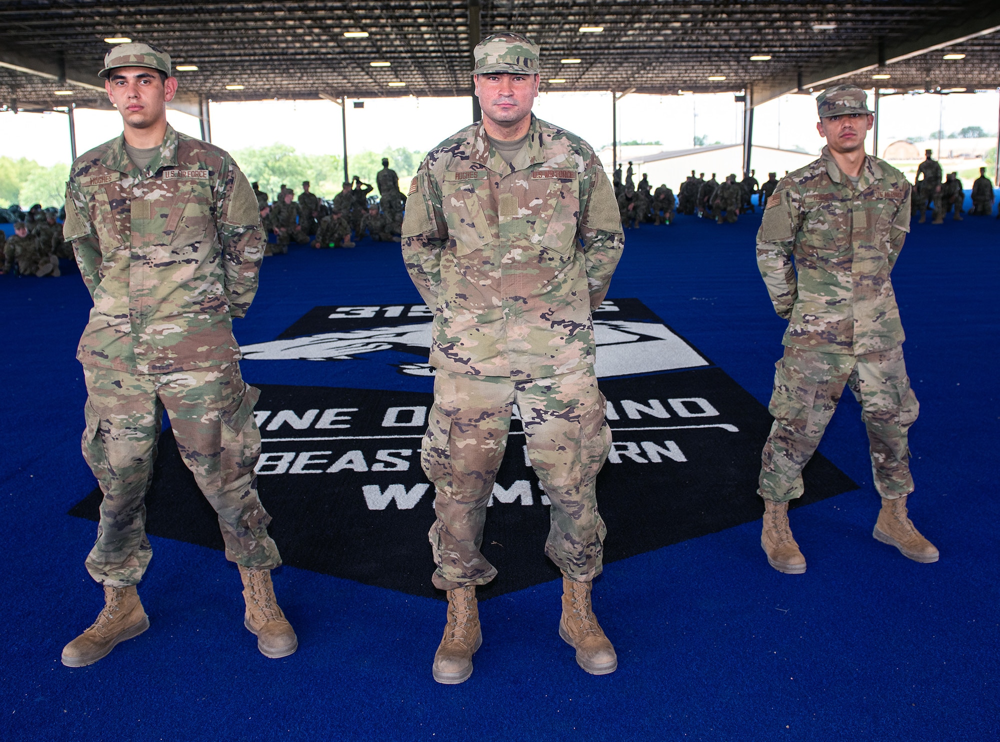 Daniel (left), Jesus (center), and Nicolas (right) Hughes, U.S. Air Force basic training trainees, pose for a photo after the BEAST graduation ceremony May 21 at Joint Base San Antonio-Chapman Annex.