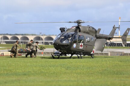 Soldiers from the Guam National Guard load a medical evacuation patient into a Lakota helicopter at Andersen Air Force Base on June 30. The Guard supported Operation Spartan Flex to exercise joint capabilities in the Indo-Pacific Command Region.