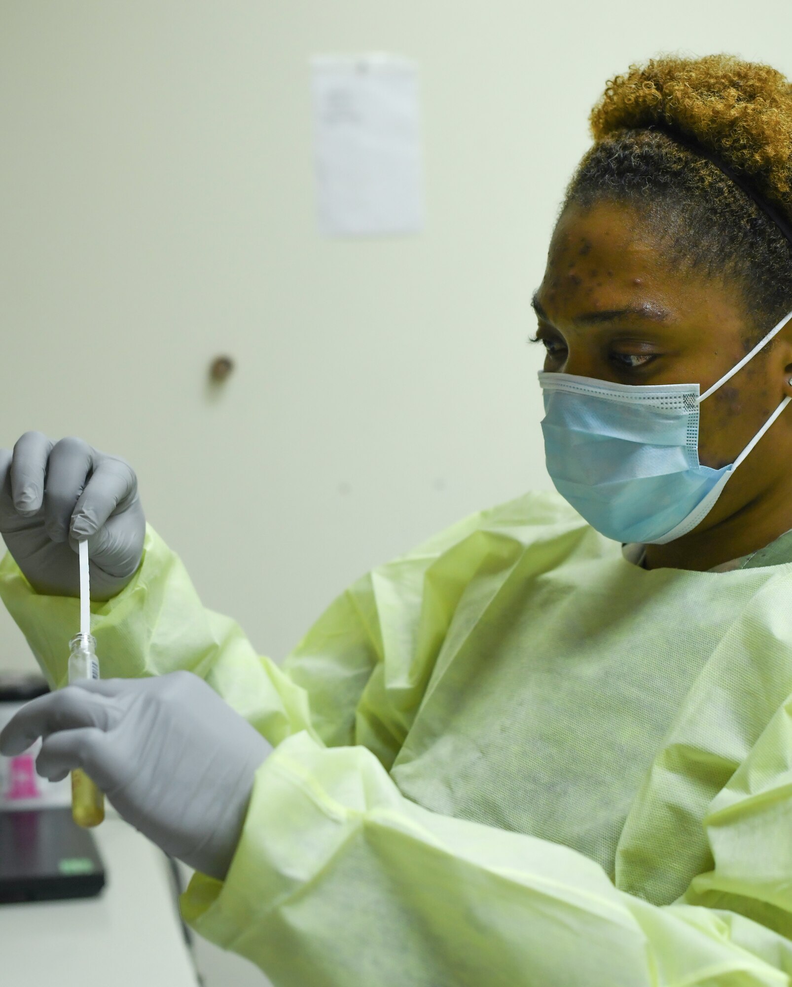 Staff Sgt. Shutyame Maryl Lisa, 380th Expeditionary Medical Group laboratory technician, preps a test strip used to calibrate a urinalysis machine Tuesday, June 30, 2020, at Al Dhafra Air Base, United Arab Emirates. In her role here, Maryl Lisa helps prevent and diagnose diseases by conducting state-of-the-art analysis. (U.S. Air Force photos Tech. Sgt. Melissa Harvey)