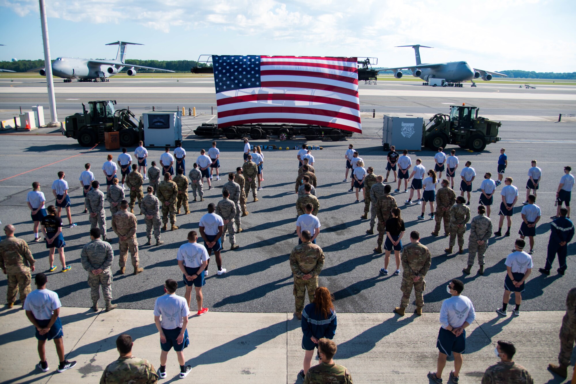 Airmen from the 436th Aerial Port Squadron stand in formation before a memorial ceremony June 29, 2020, at Dover Air Force Base, Delaware. Airmen were required to wear masks and adhere to social distancing regulations. (U.S. Air Force photo by Airman 1st Class Faith Schaefer)