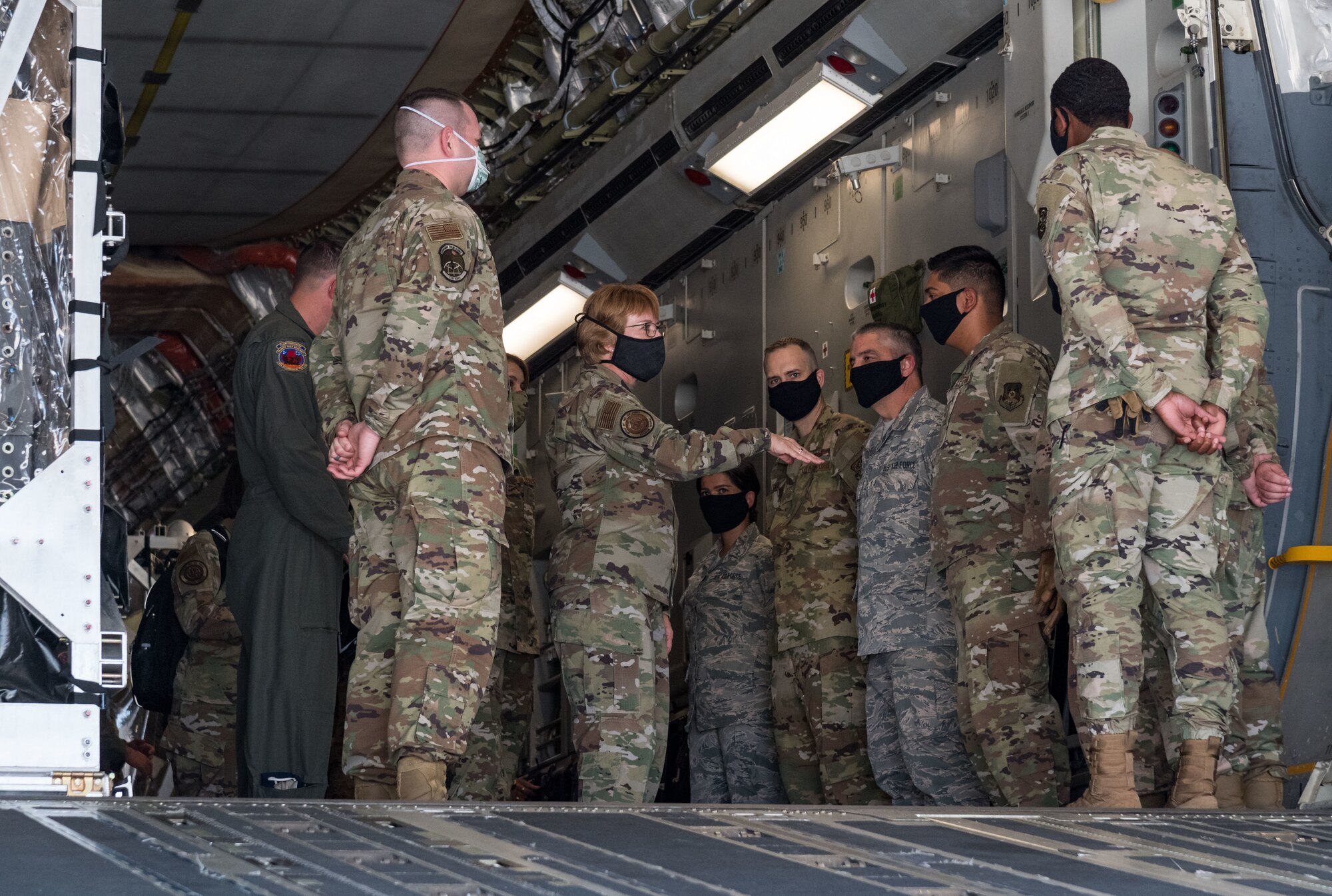 Lt. Gen. Dorothy Hogg, U.S. Air Force surgeon general, talks with Transport Isolation System support team members June 26, 2020, at Dover Air Force Base, Delaware. Dover serves as the U.S. East Coast hub for the Transport Isolation System. (U.S. Air Force photo by Roland Balik)