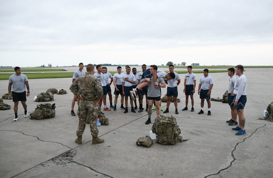 Team Minot Airmen are taught how to do a fireman's carry June 8, 2020, at Minot Air Force Base, North Dakota. A fireman’s carry is the most effective way to carry an injured person. (U.S. Air Force Photos By Airman 1st Class Caleb S. Kimmell)
