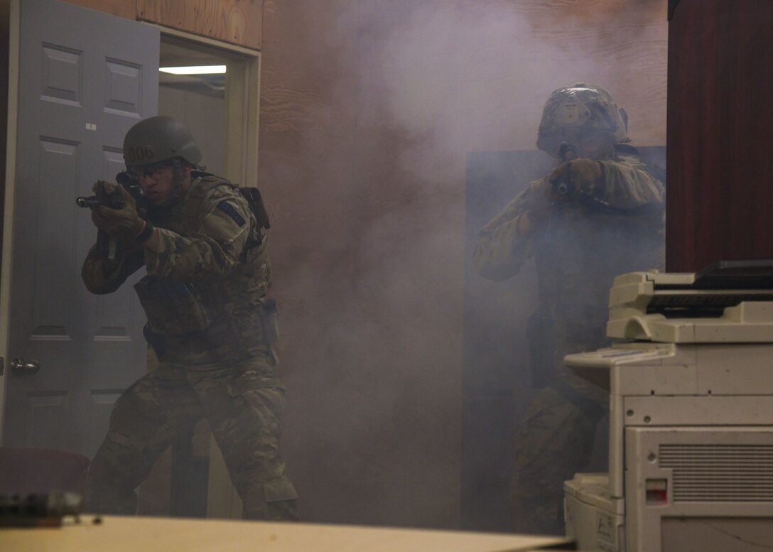 Team Minot Airmen practice entry procedures and close quarters combat June 15, 2020, at Minot Air Force Base, North Dakota. The Airmen can use tools like flashbangs and breaching hammers to enter a room. (U.S. Air Force Photos By Airman 1st Class Caleb S. Kimmell)