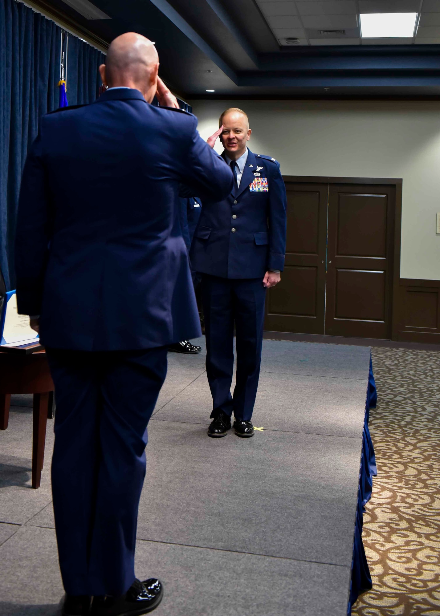 U.S. Air Force Col. Derek Salmi, outgoing 92nd Air Refueling Wing commander, salutes Maj. Gen. Sam Barrett, 18th Air Force commander, during the 92nd ARW change of command ceremony