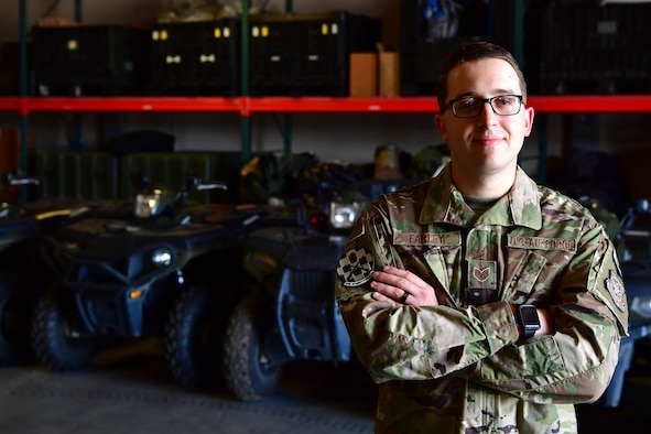 A man stands in uniform.