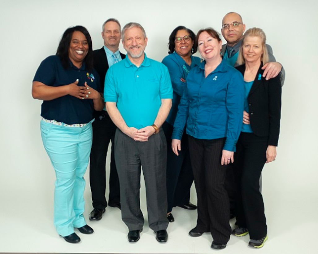 Several People and Culture associates wearing teal to promote SAPR awareness and show DLA’s support for survivors.