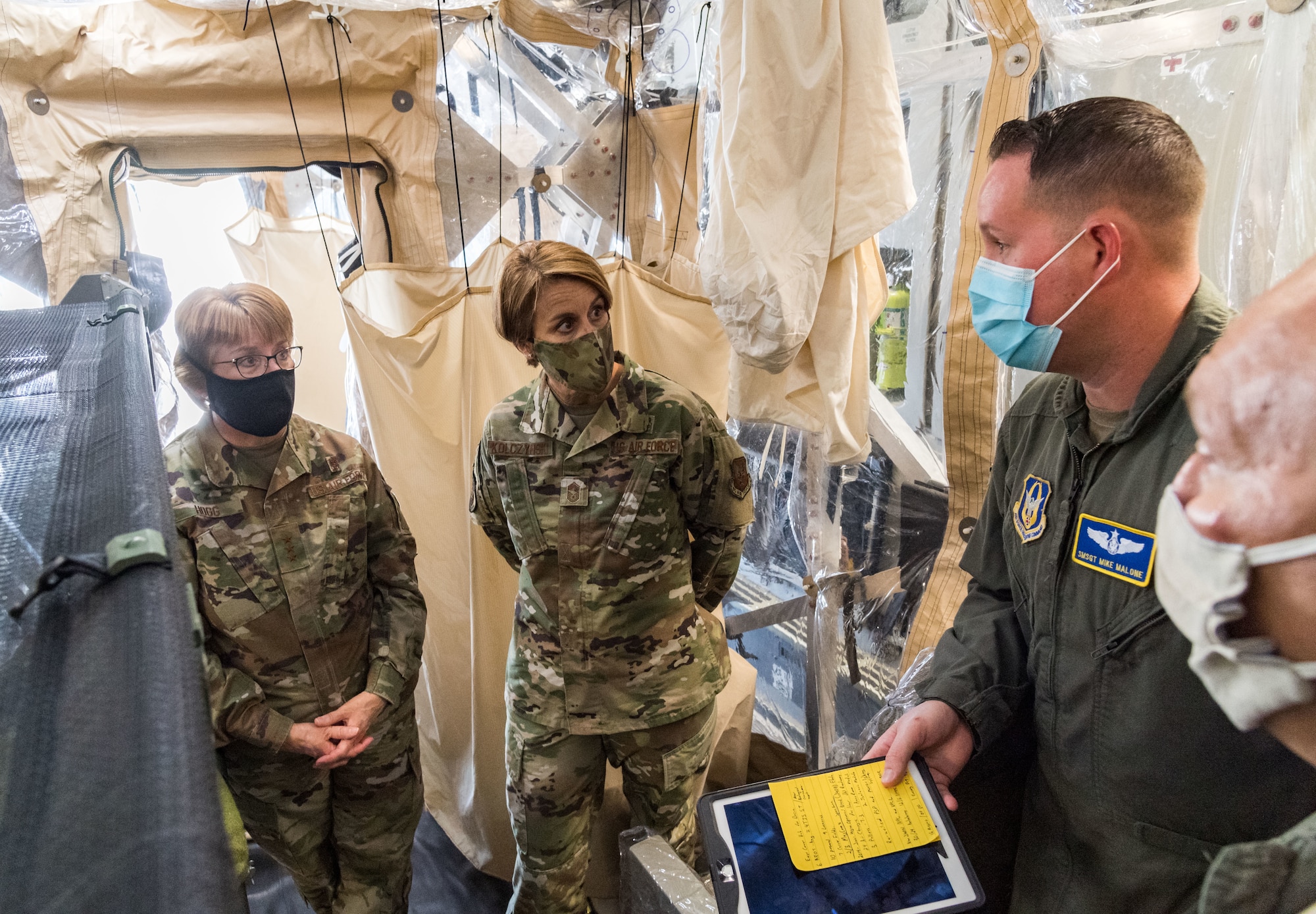 From the left, Lt. Gen. Dorothy Hogg, U.S. Air Force surgeon general, and Chief Master Sgt. Dawn Kolczynski, AF/SG chief of medical operations, talk with Senior Master Sgt. Michael Malone, 36th Aeromedical Evacuation Squadron training noncommissioned officer in charge and AE technician, and Maj. Mark Dellinger, 36th AES training flight commander, both from Keesler Air Force Base, Mississippi, inside a Transport Isolation System, June 26, 2020, at Dover Air Force Base, Delaware. Dover serves as the U.S. East Coast hub for the TIS. (U.S. Air Force photo by Roland Balik)