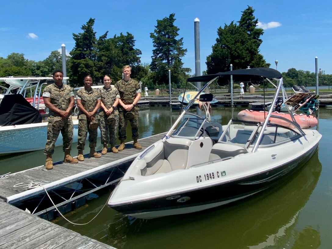 U.S. Marines stand in front of the boat they used to help rescue a father and son on the Potomac River in Nanjemoy, Maryland, June 14.