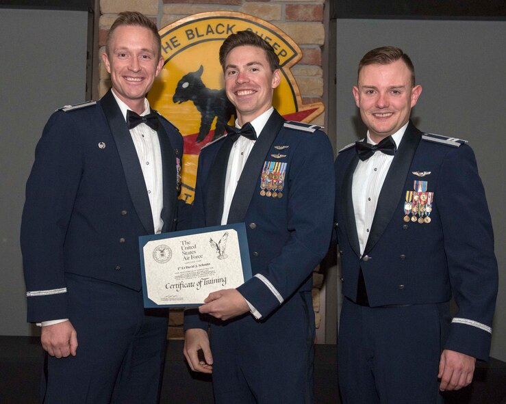1st Lt David Schmitz (middle), receives his certificate of training during the 8th Fighter Squadron’s F-16 Basic Course graduation on Holloman Air Force Base, N.M., Dec. 14, 2019. Schmitz was killed when his F-16 crashed during a routine training mission while stationed at Shaw AFB, S.C., June 30, 2020. (U.S. Air Force photo by Staff Sgt. Christine Groening)