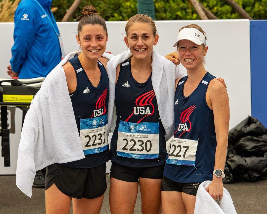 U.S. Marine Corps 1st Kt. Lindsay Carrick, Navy Lt. Katherine Irgens and Army Maj. Amy Natalini, U.S Armed Forces Marathon Team members, share a smile after crossing the finish line during the 7th Conseil International du Sport Militaire World Games in Wuhan, China Oct. 27, 2019. (U.S. Army photo by Staff Sgt. Vito T. Bryant)