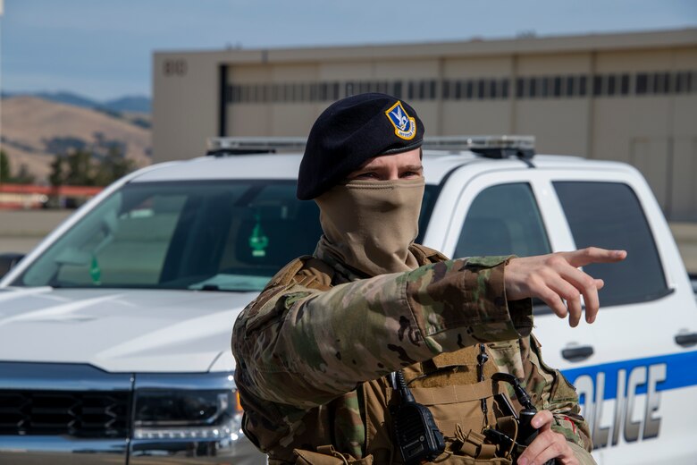 U.S. Air Force Staff Sgt. Brenden Rinehart, 60th Security Forces Squadron patrolman, points out an area to investigate May 16, 2020, prior to a flight line perimeter check at Travis Air Force Base, California. Security forces Airmen complete checks of the flight line daily. (U.S. Air Force photo by Tech. Sgt. James Hodgman)