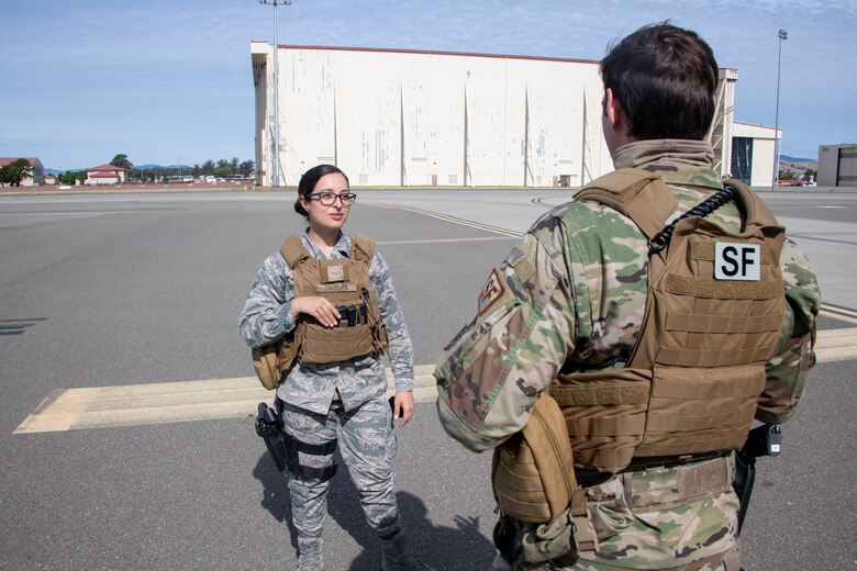 U.S. Air Force Airman 1st Class Stephanie DaSilva, left, 60th Security Forces Squadron installation entry controller, discusses the plan to conduct a perimeter check with Staff Sgt. Brenden Rinehart, 60th SFS patrolman, May 16, 2020, on the flight line at Travis Air Force Base, California. Security forces Airmen complete checks of the flight line daily. (U.S. Air Force photo by Tech. Sgt. James Hodgman)
