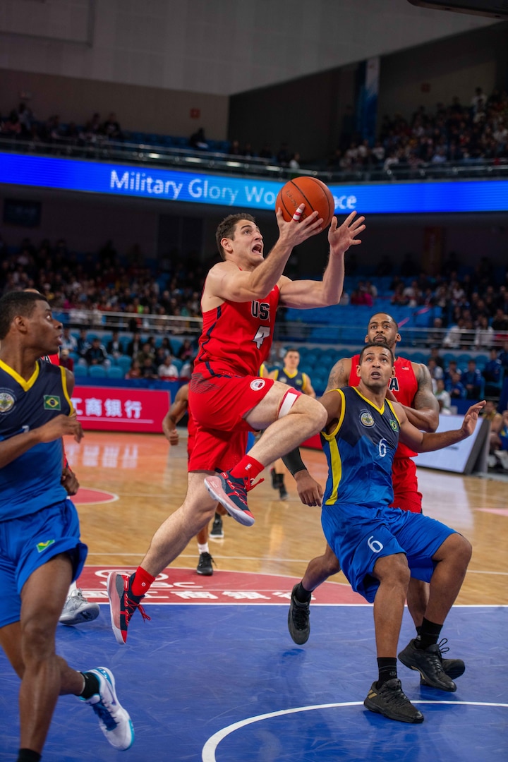 U.S. Navy Lt. Junior Grade Grant Vermeer, U.S Armed Forces Men’s Basketball Team member, soars past a competitor for a layup during the 7th Conseil International du Sport Militaire World Games in Wuhan, China Oct. 25, 2019. The U.S. team defeated Brazil 78-61 to advance to the gold medal game against the Lithuania. (U.S. DoD photo by Staff Sgt. Vito T. Bryant)