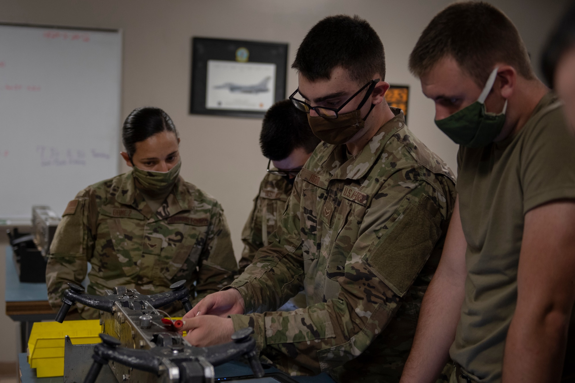 Airmen remove cart liners on bomb racks