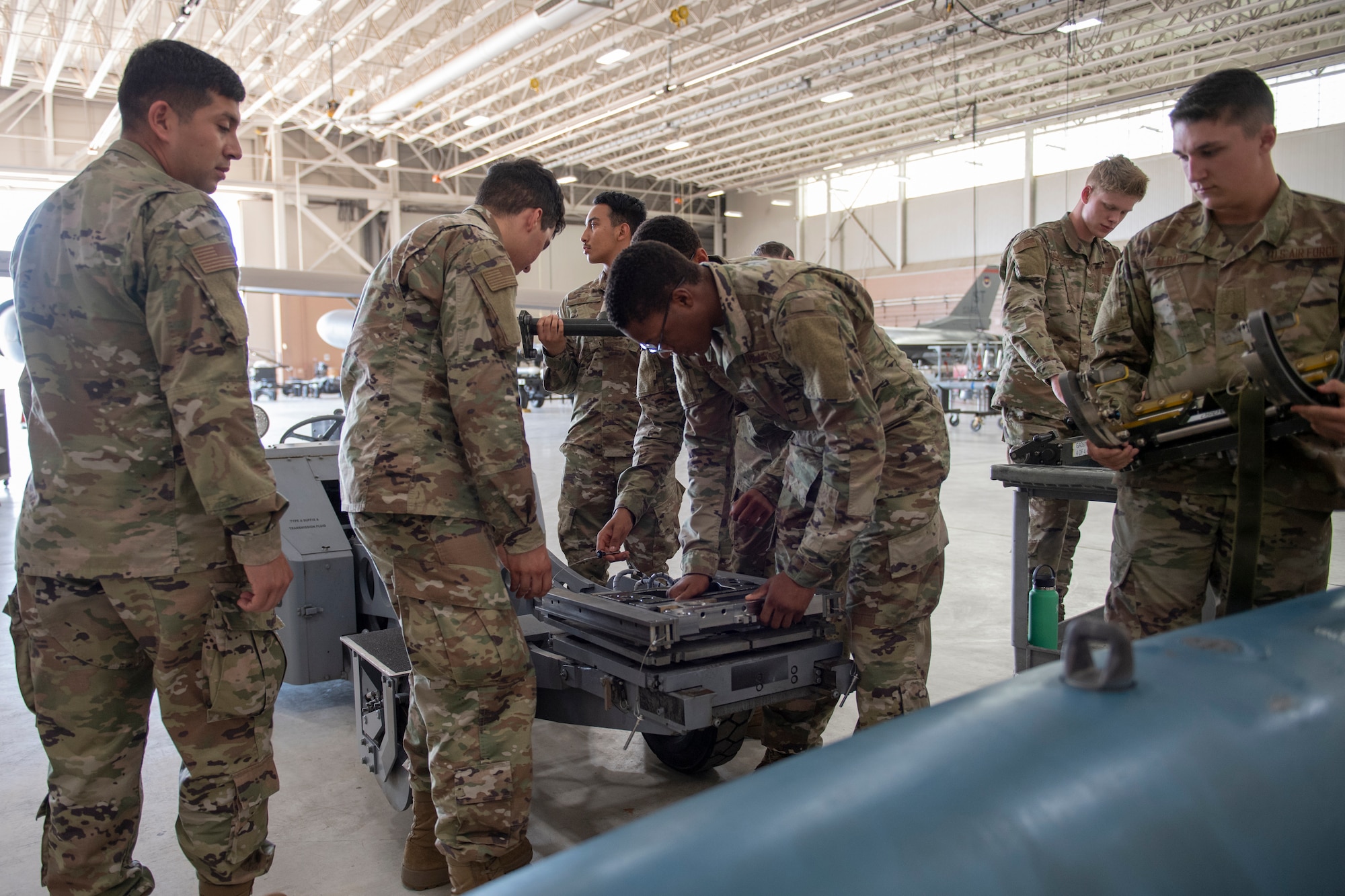 Airmen learn to disassemble and inspect a missile loading adapter