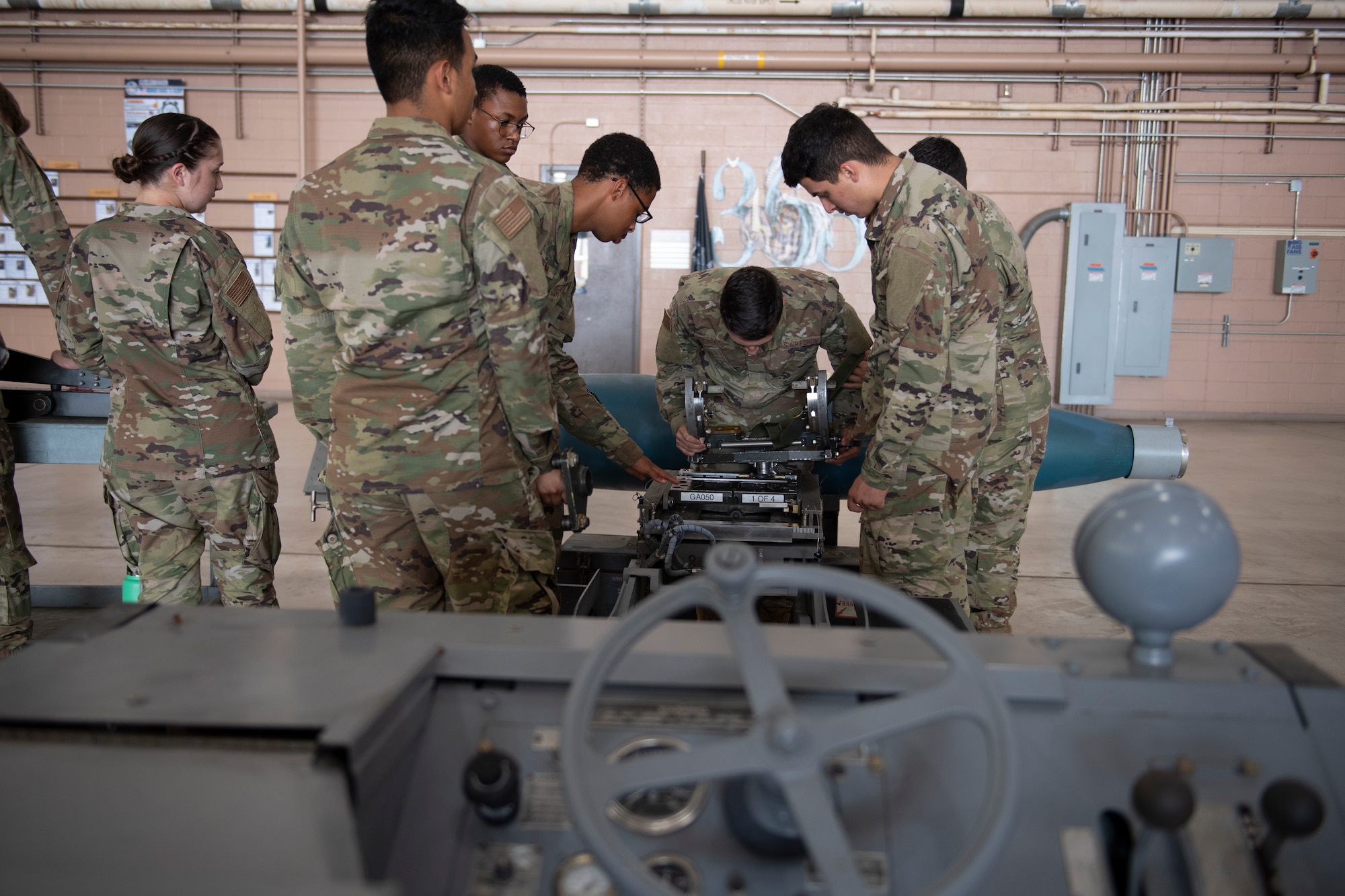Airmen learn to disassemble and inspect a missile loading adapter