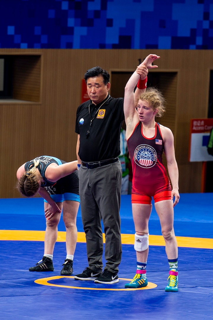 Army Staff Sgt. Whitney Conder with the U.S. Armed Forces Wrestling Team is announced as the victor against Kseniya Stankevich of Belarus, 9-2, in the 50kg. weight class at the Military World Games in Wuhan, China, Oct. 22, 2019. Conder earned a silver medal in the games. (DoD photo by Mass Communication Specialist 1st Class Ian Carver.)