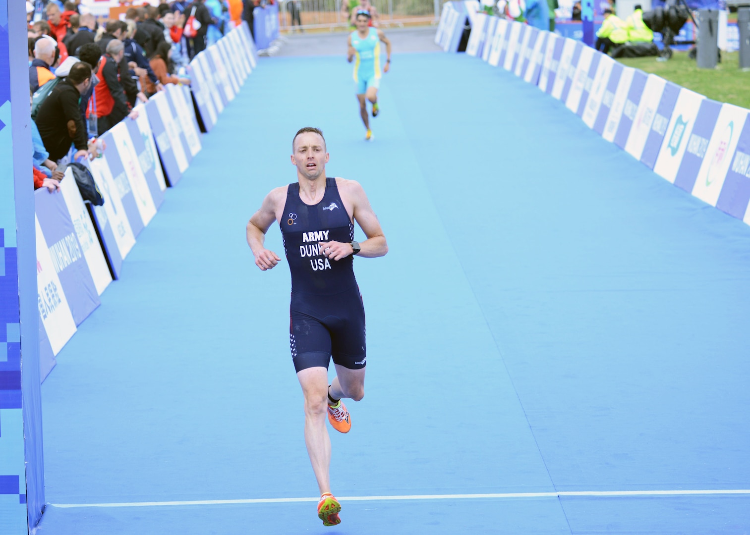 U.S. Army Lt. Col. Bryan Dunker crosses the finish line of the men's triathlon awith a time of 2:03:12 at the Military World Games in Wuhan, China, Oct. 27, 2019. He finished 12th in the men's senior division, helping secure a silver medal for the USA mixed seniors team.