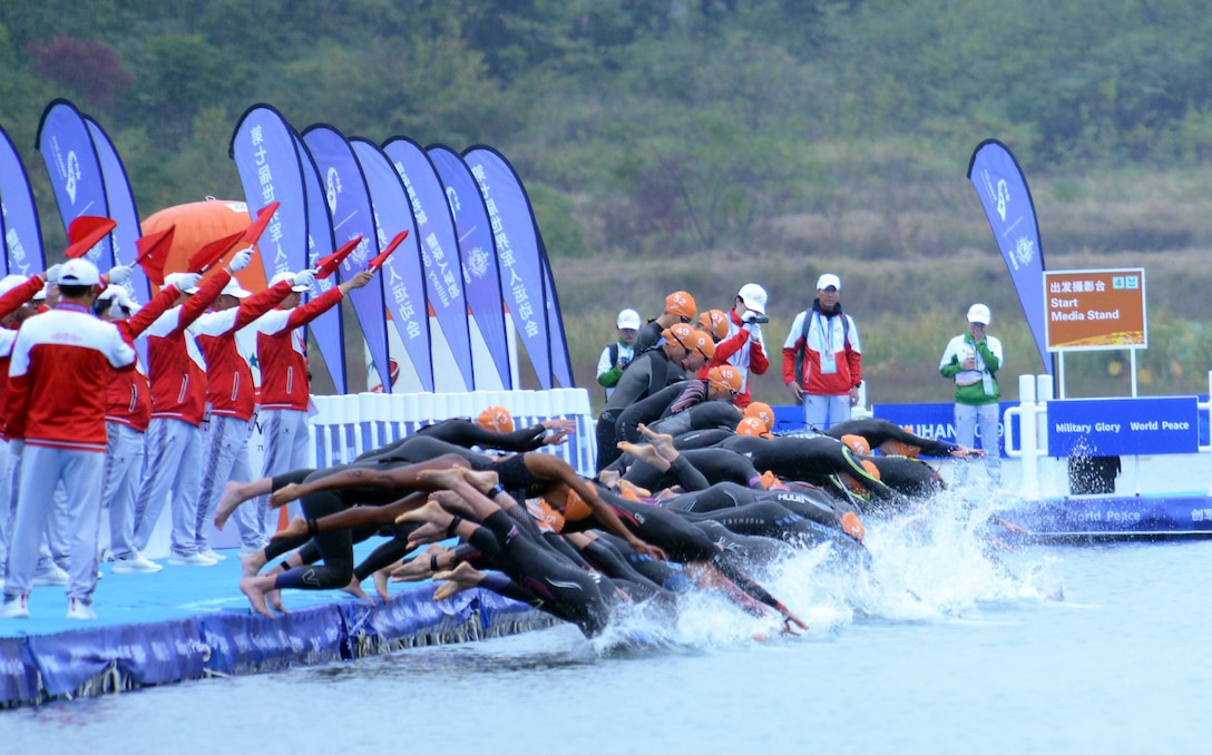 Competitors enter the water for the 1500-meter swim to begin the women's triathlon at the Military World Games in Wuhan, China, Oct. 27, 2019. Air Force Maj. Judith Coyle finished first in the senior women's division, winning gold for the USA.