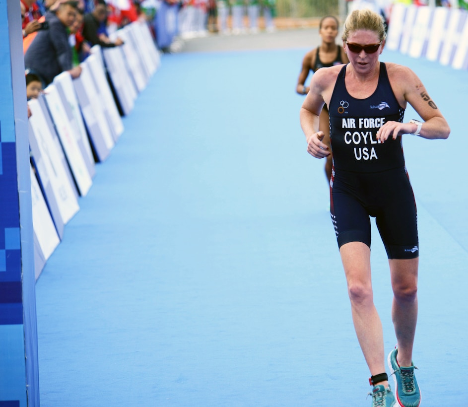Air Force Reserve Lt. Col Judith Coyle crosses the finish line to win a gold medal for the USA in the triathlon women's senior division with a time of 2:09:46 during the CISM World Military Games, Oct. 27, 2019.
