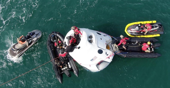 Airmen execute open water rescue training.