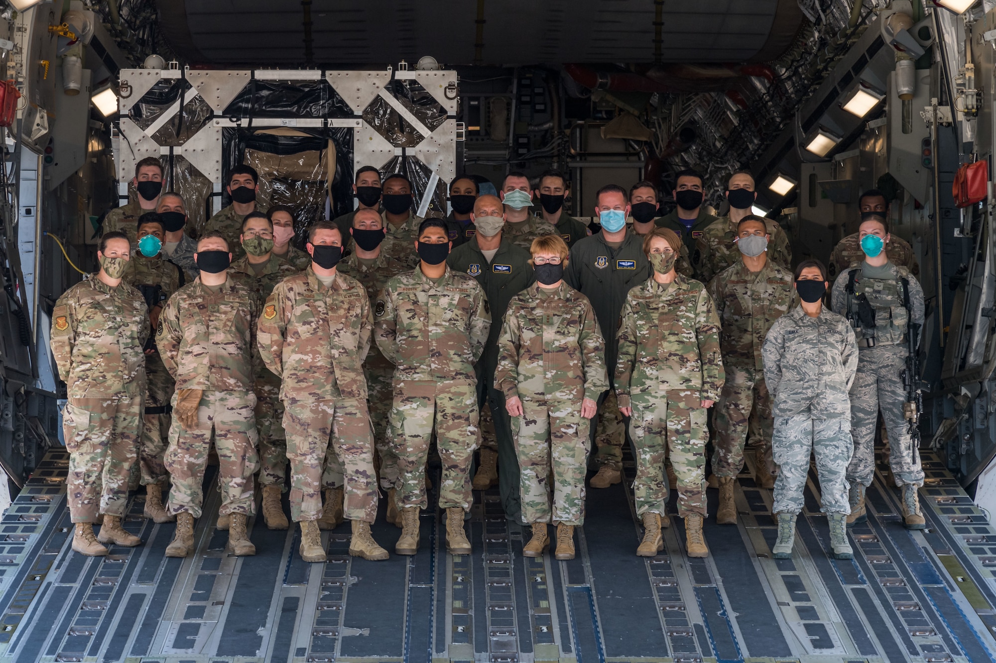 Lt. Gen. Dorothy Hogg, U.S. Air Force surgeon general, and Chief Master Sgt. Dawn Kolczynski, AF/SG chief of medical operations, pose for a photo on the ramp of a C-17 Globemaster III, June 26, 2020, at Dover Air Force Base, Delaware. Other personnel in the photo were Dover AFB senior leadership, 10th Expeditionary Aeromedical Evacuation Flight aircrew, the Transport Isolation System support team, 736th Aircraft Maintenance Squadron and 436th Security Forces Squadron personnel (U.S. Air Force photo by Roland Balik)