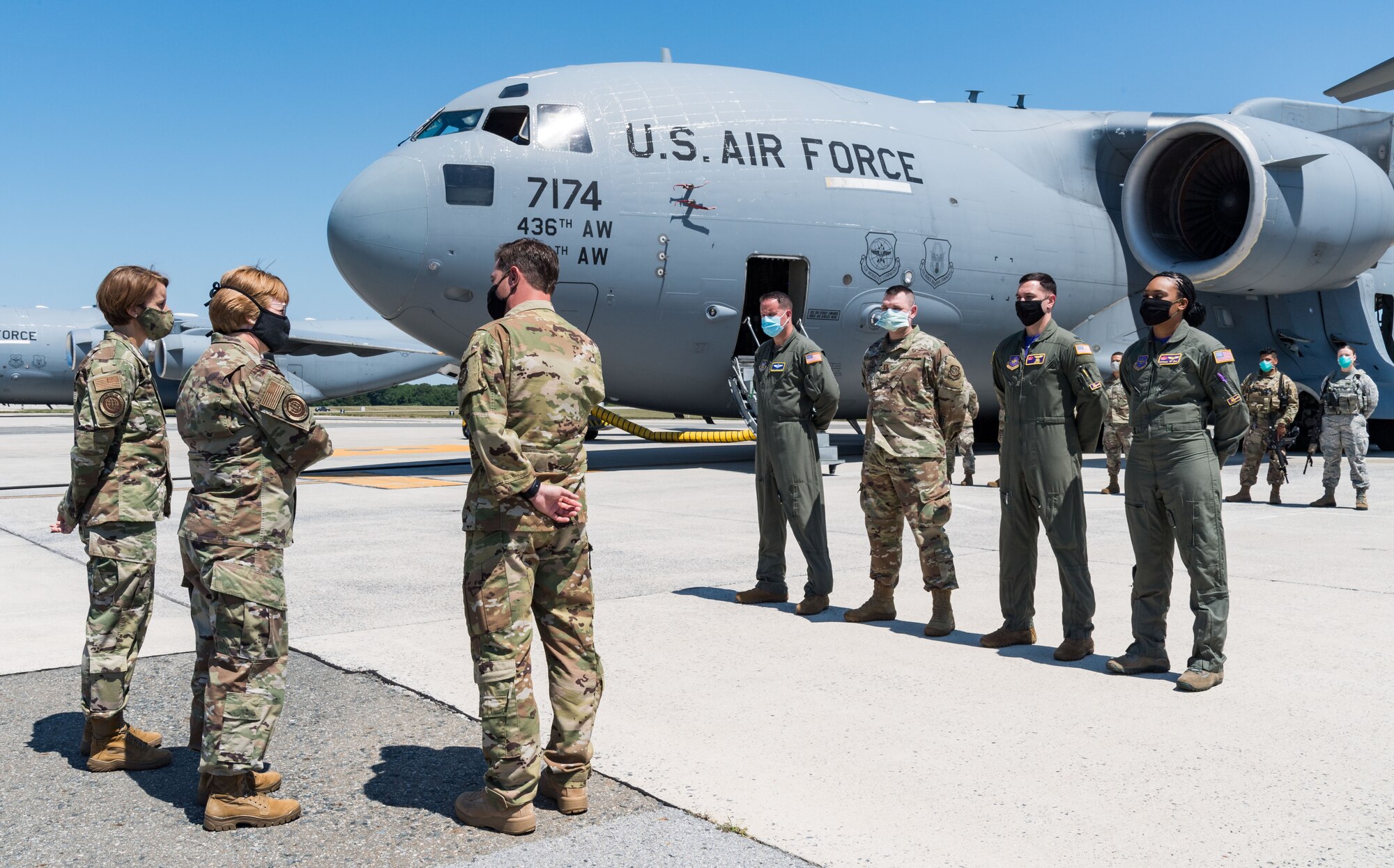 Capt. Travis Parrot, 3rd Airlift Squadron pilot and stage representative, talks with Lt. Gen. Dorothy Hogg, U.S. Air Force surgeon general, and Chief Master Sgt. Dawn Kolczynski, AF/SG chief of medical operations, in front of a C-17 Globemaster III, June 26, 2020, at Dover Air Force Base, Delaware. Hogg and Kolczynski were given a briefing on the Transport Isolation System and met with 10th Expeditionary Aeromedical Evacuation Flight aircrew, the TIS support team and 736th Aircraft Maintenance Squadron personnel. (U.S. Air Force photo by Roland Balik)