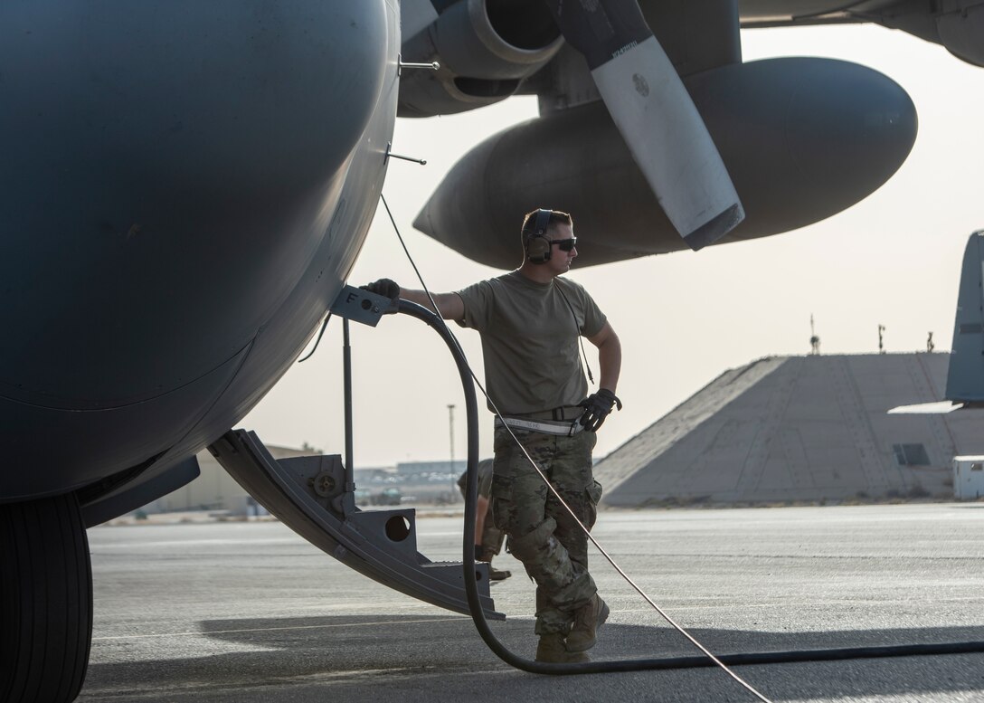 stands next to a C-130