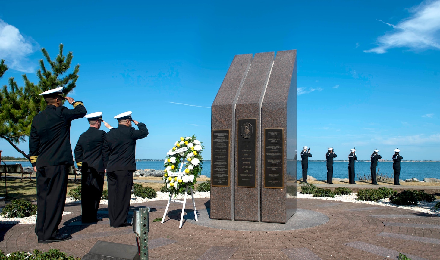 Sailors assigned to the Arleigh Burke-class guided missile-destroyer USS Cole (DDG 67) render honors at the USS Cole Memorial at Naval Station Norfolk during a commemoration of the Oct. 12, 2000 terrorist attack in Yemen that killed 17 Sailors.
