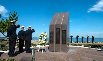 Sailors assigned to the Arleigh Burke-class guided missile-destroyer USS Cole (DDG 67) render honors at the USS Cole Memorial at Naval Station Norfolk during a commemoration of the Oct. 12, 2000 terrorist attack in Yemen that killed 17 Sailors.