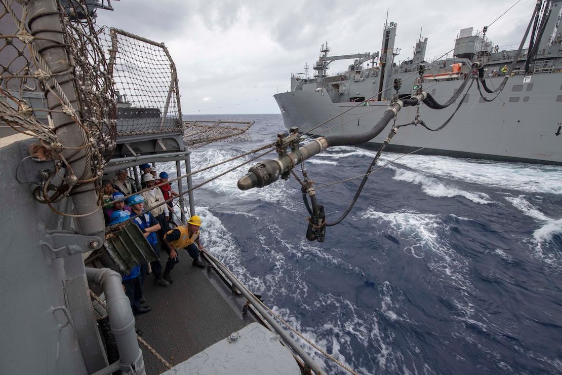 Sailors aboard the Ticonderoga-class guided-missile cruiser USS Antietam (CG 54) prepare to receive a fuel line during a replenishment-at-sea with the Lewis and Clark-class dry cargo ship USNS Carl Brashear (T-AKE 7)